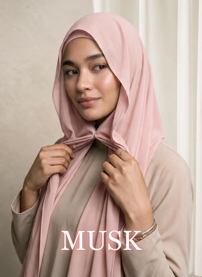 Woman wearing NurAmira™ Instant Chiffon Hijab in Musk, holding the front drape beneath her chin.