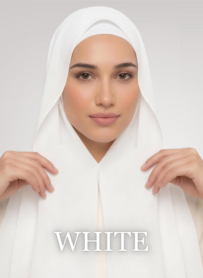 Woman wearing white NurAmira instant chiffon hijab with front panels held by magnets and smooth drape in white studio