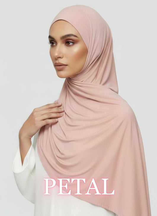 Woman wearing blush Jersey hijab with soft airy drape in white studio