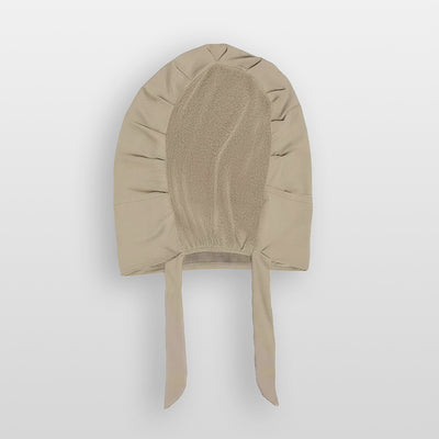 Flat lay of praline beige Amina velvet hold undercap with mesh back and adjustable tie-back in white studio