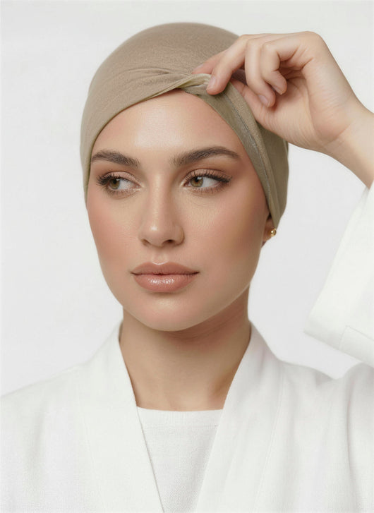 Model lifting praline beige Amina velvet hold undercap to reveal velvet grip front panel in white studio