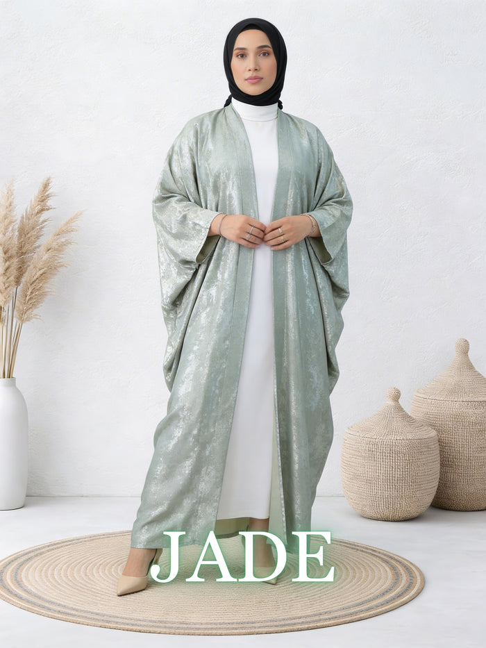 Woman wearing Safiya jade abaya with elegant movement and relaxed layered design