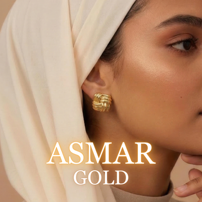 Woman wearing Asmar sculpted gold earrings with light hijab in sunlight