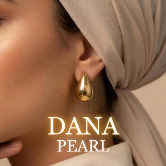 Woman wearing Dana gold drop earrings with soft beige hijab