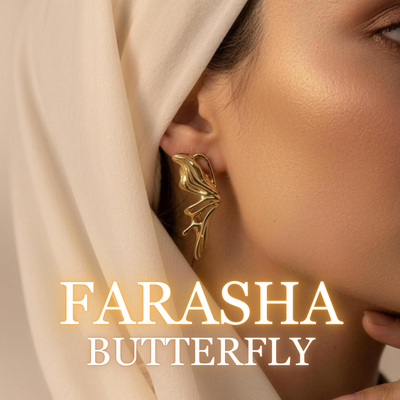 Woman wearing Farasha gold statement earrings with flowing hijab close-up