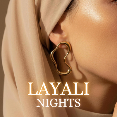 Woman wearing Layali gold earrings with flowing hijab in golden light