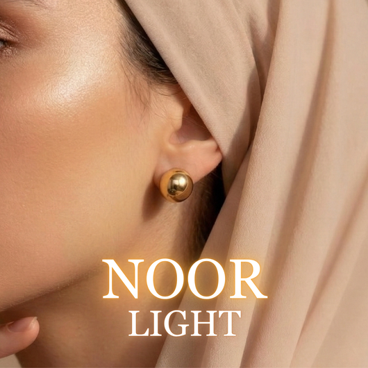 Woman wearing Noor gold stud earrings with neutral hijab close-up