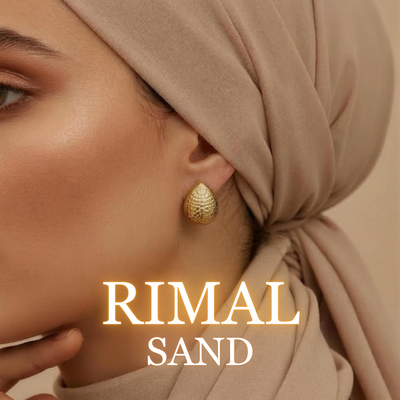 Woman wearing Rimal textured gold earrings with tied hijab close-up
