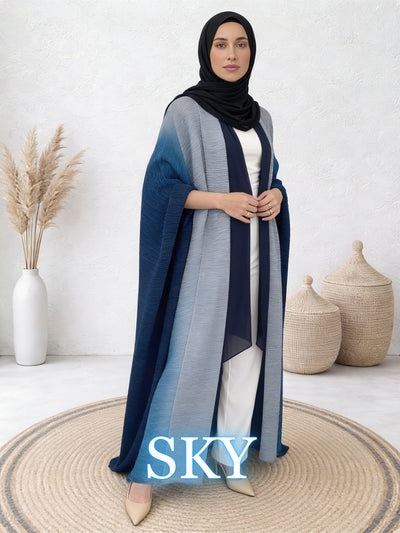 Woman wearing Sultana sky abaya with flowing layers and modern drape