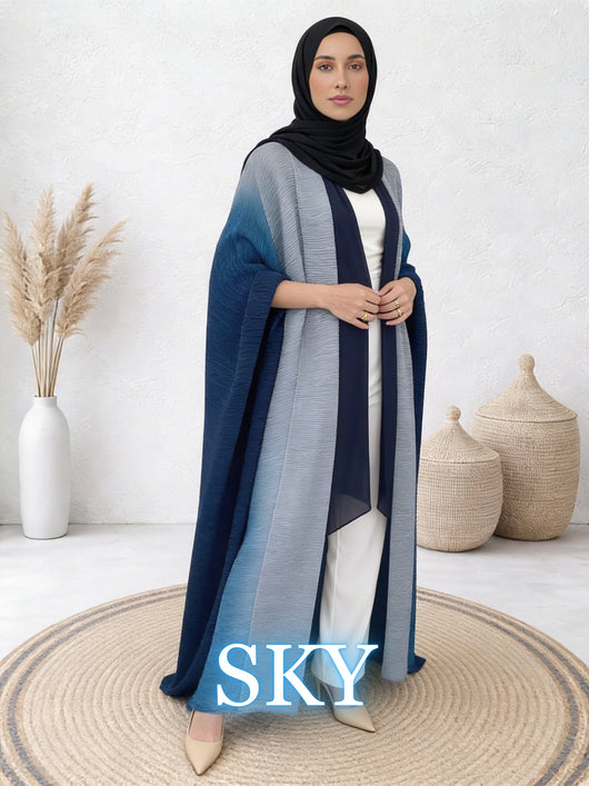 Woman wearing Sultana sky abaya with flowing layers and modern drape