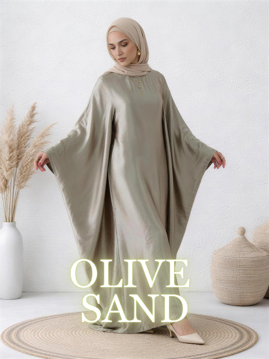 Woman wearing Yasmin abaya in olive sand with luminous satin finish