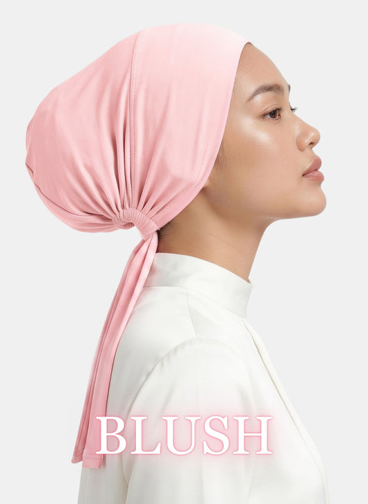 Zeenah Silk Undercap in Blush worn by a model, highlighting its smooth silhouette and tie-back design.