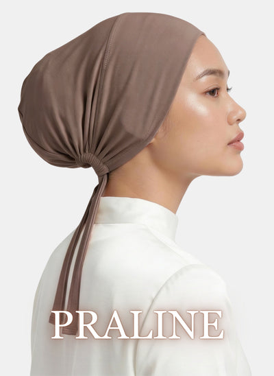 Close-up side view of a model wearing the Zeenah Silk Undercap in Praline.