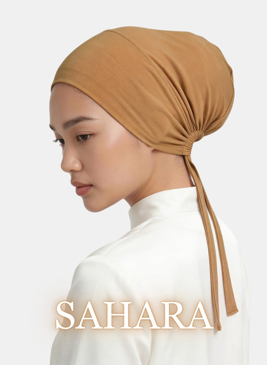 Minimal studio image of the Zeenah Silk Undercap in Sahara worn by a model.