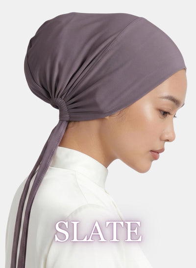 The Zeenah Silk Undercap in Slate featuring a soft drape and adjustable back ties.