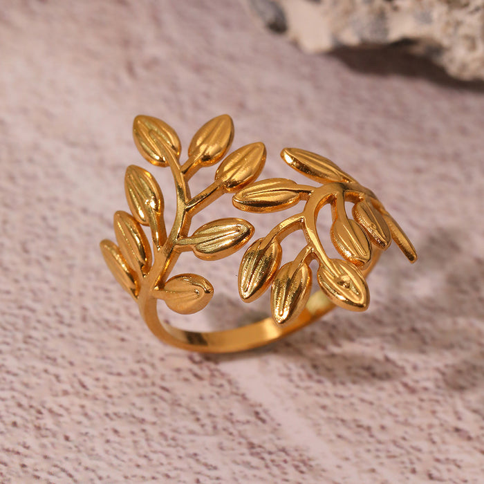 Noora olive leaf ring in gold on textured stone background