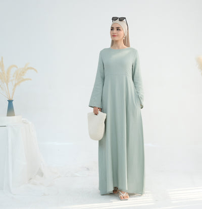 Linen abaya in emerald worn by model